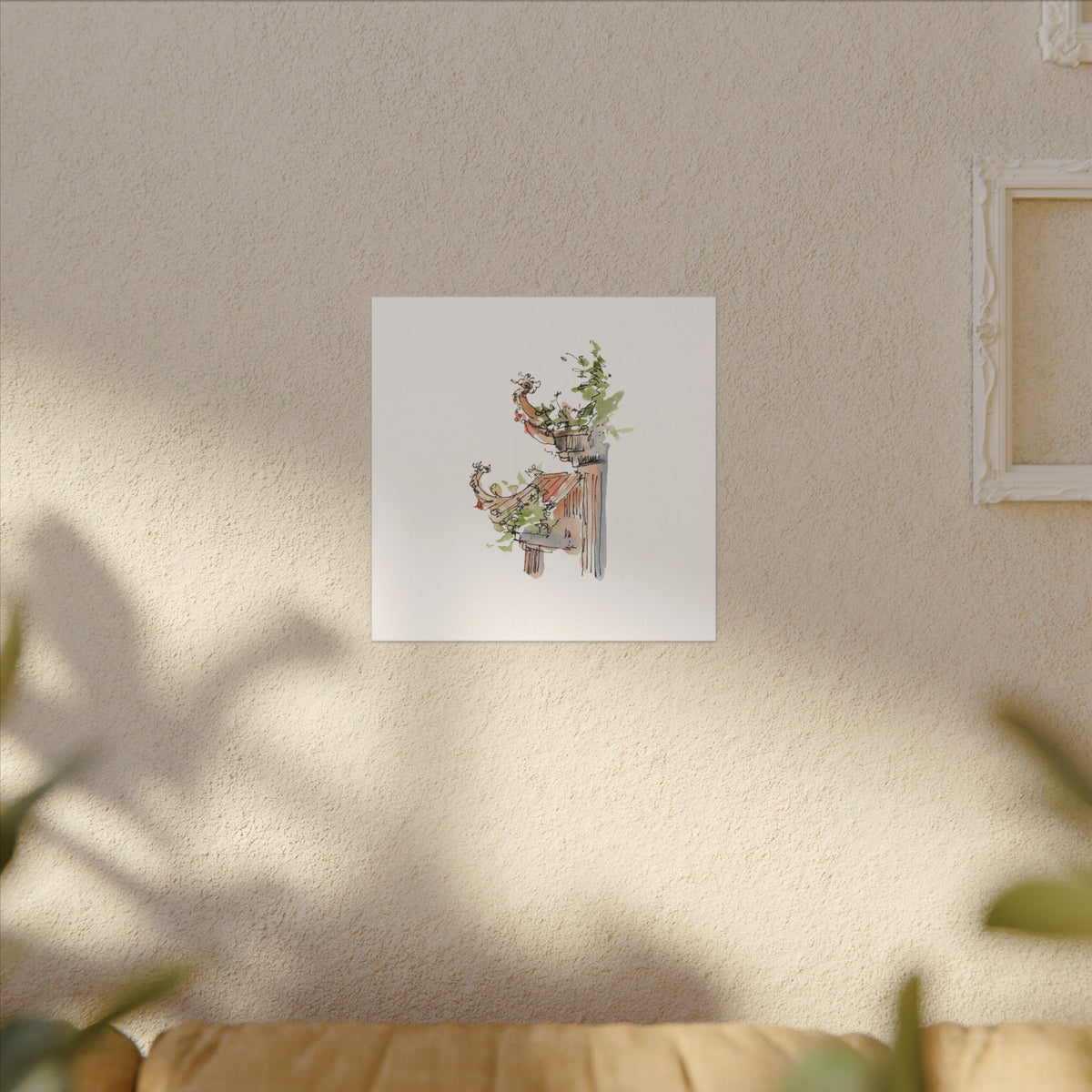 Framed artwork of a deer with flowers on a beige wall.